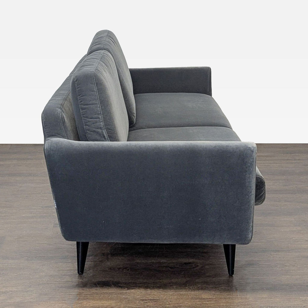 Modern 3-seat Sits For Crate And Barrel sofa in dark gray, featuring supportive armrests and sturdy black legs.