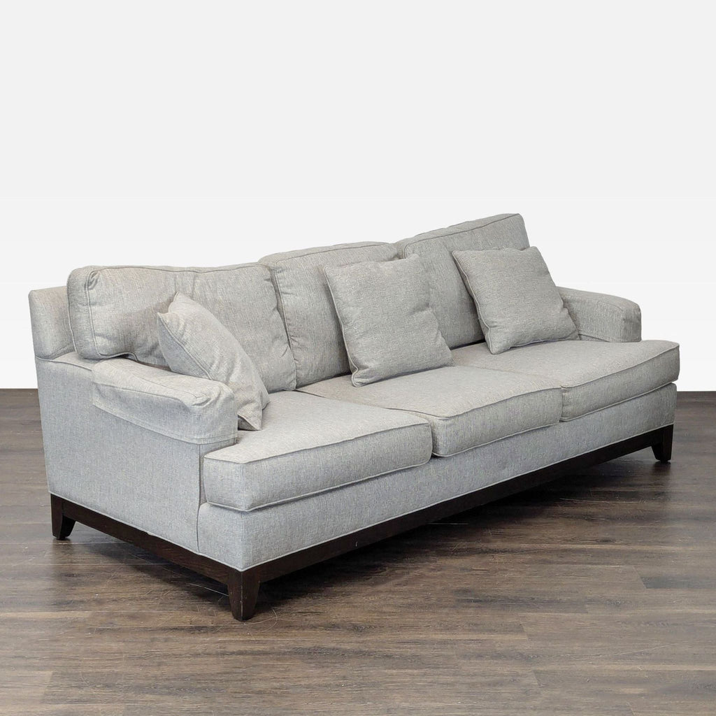 Gray 3-seat Ethan Allen sofa with clean lines, neutral color, and four cushions, suitable for any decor.  