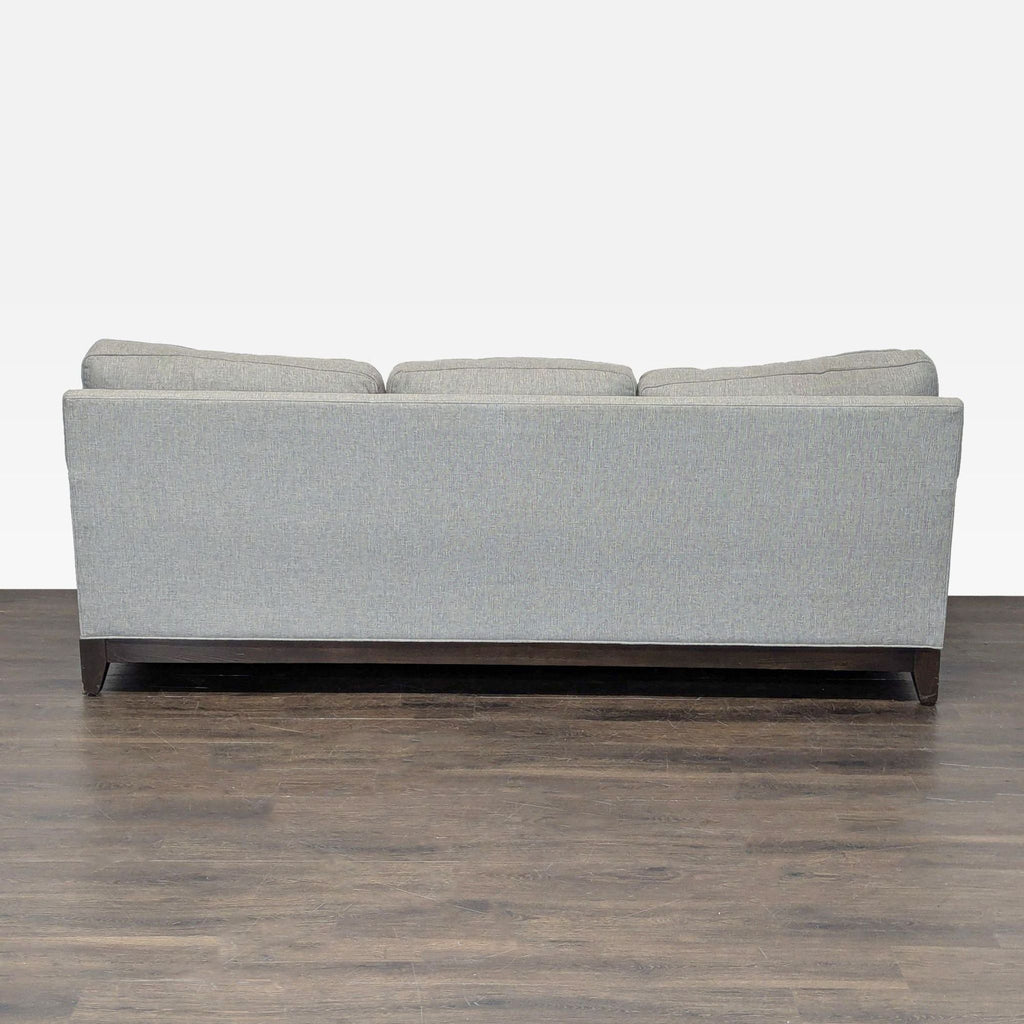 Contemporary Ethan Allen gray sofa for living room, featuring three seats and four plush, matching pillows.