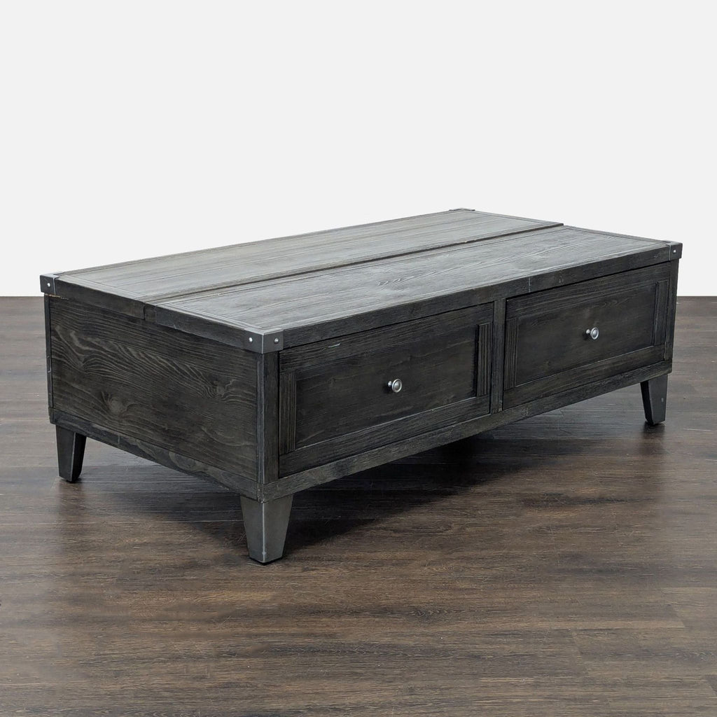 Ashley Furniture lift-top coffee table in weathered dark gray pine with canted metal legs and storage drawers.
