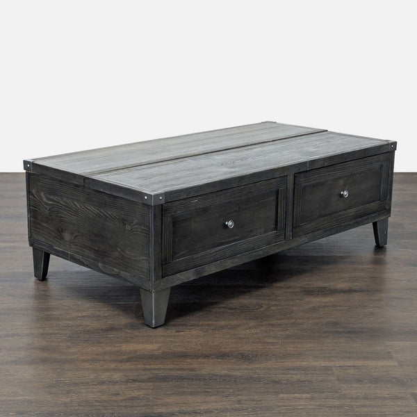 Ashley Furniture lift-top coffee table in weathered dark gray pine with canted metal legs and storage drawers.