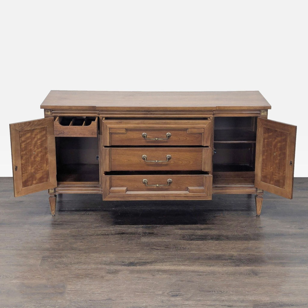 1960s Thomasville sideboard in sturdy wood, featuring three drawers and side cabinets, one with inserts.