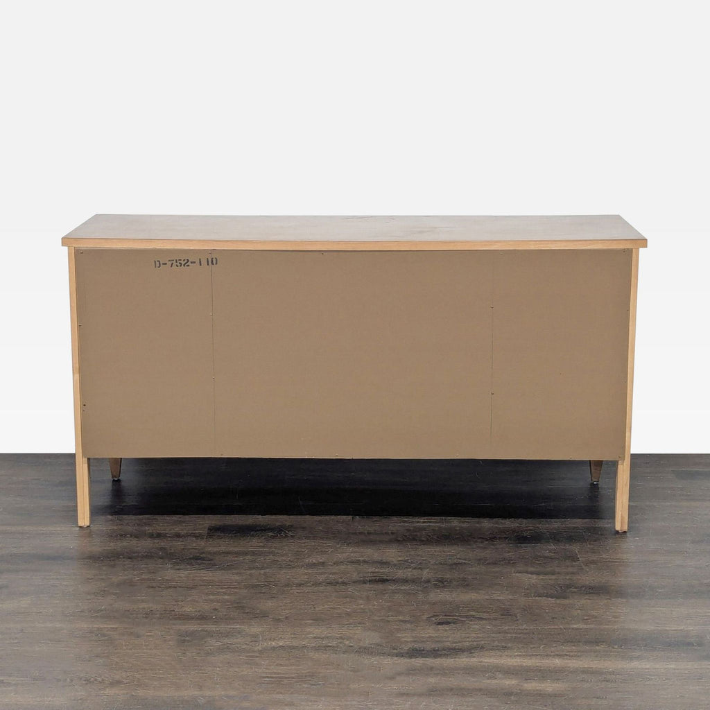 Mid-century Thomasville buffet with ornate design, central drawers, and storage cabinets, classic wood finish.