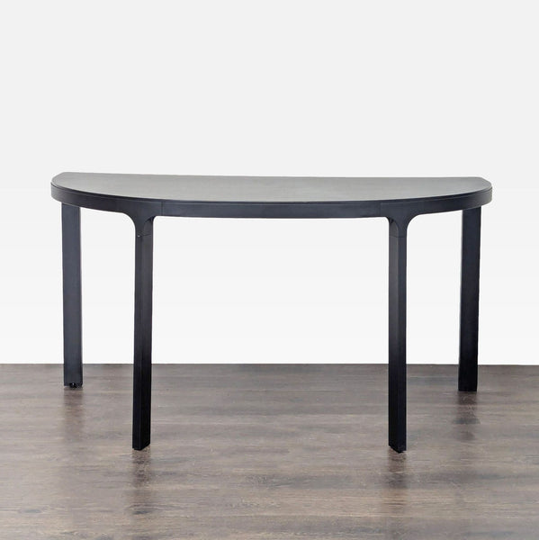 Ikea half-moon black table with modern design, perfect as a side or entryway console against a wall.  