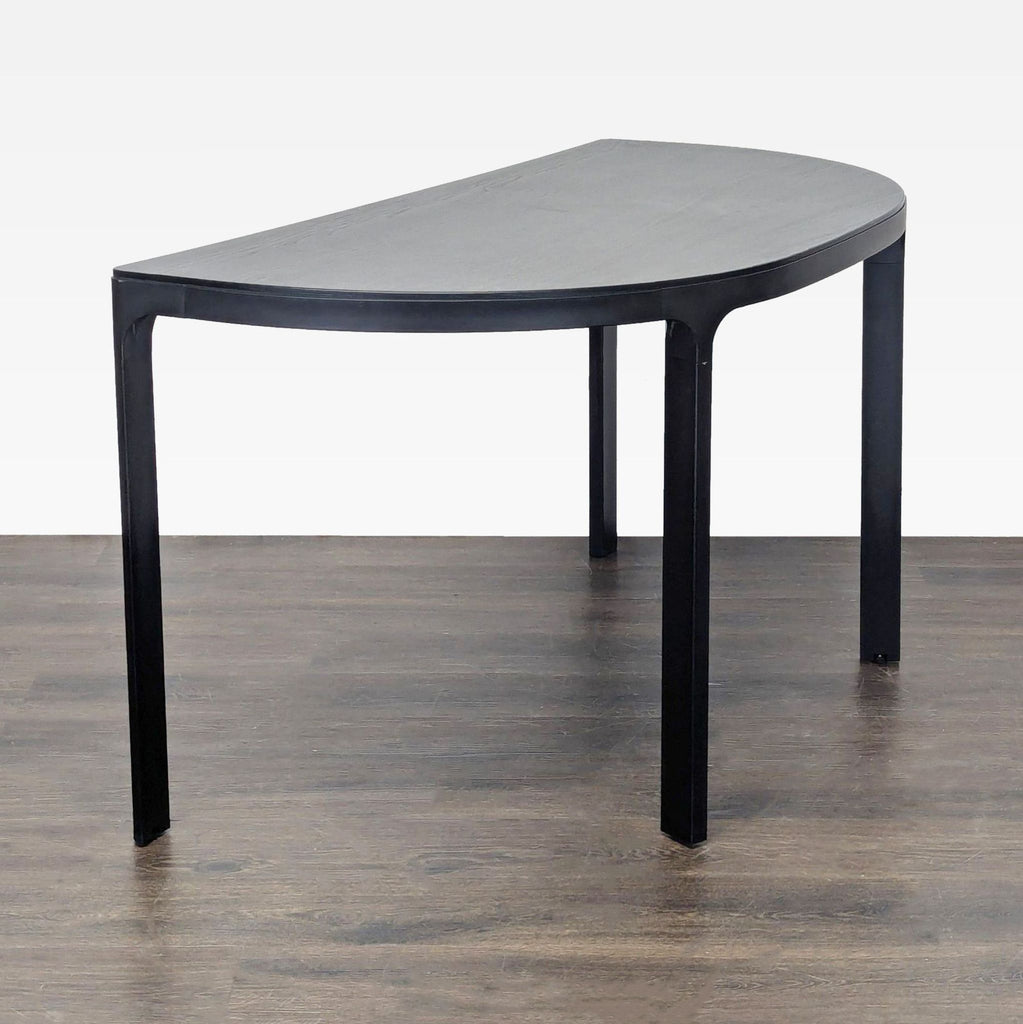 Sleek black Ikea table with a semicircular shape, sturdy build, and smooth surface for decor or storage.  