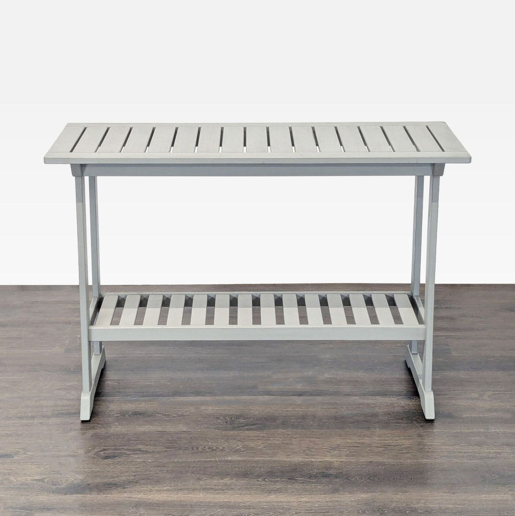 Compact gray Ikea side table with slatted top and lower storage shelf, ideal for small spaces.