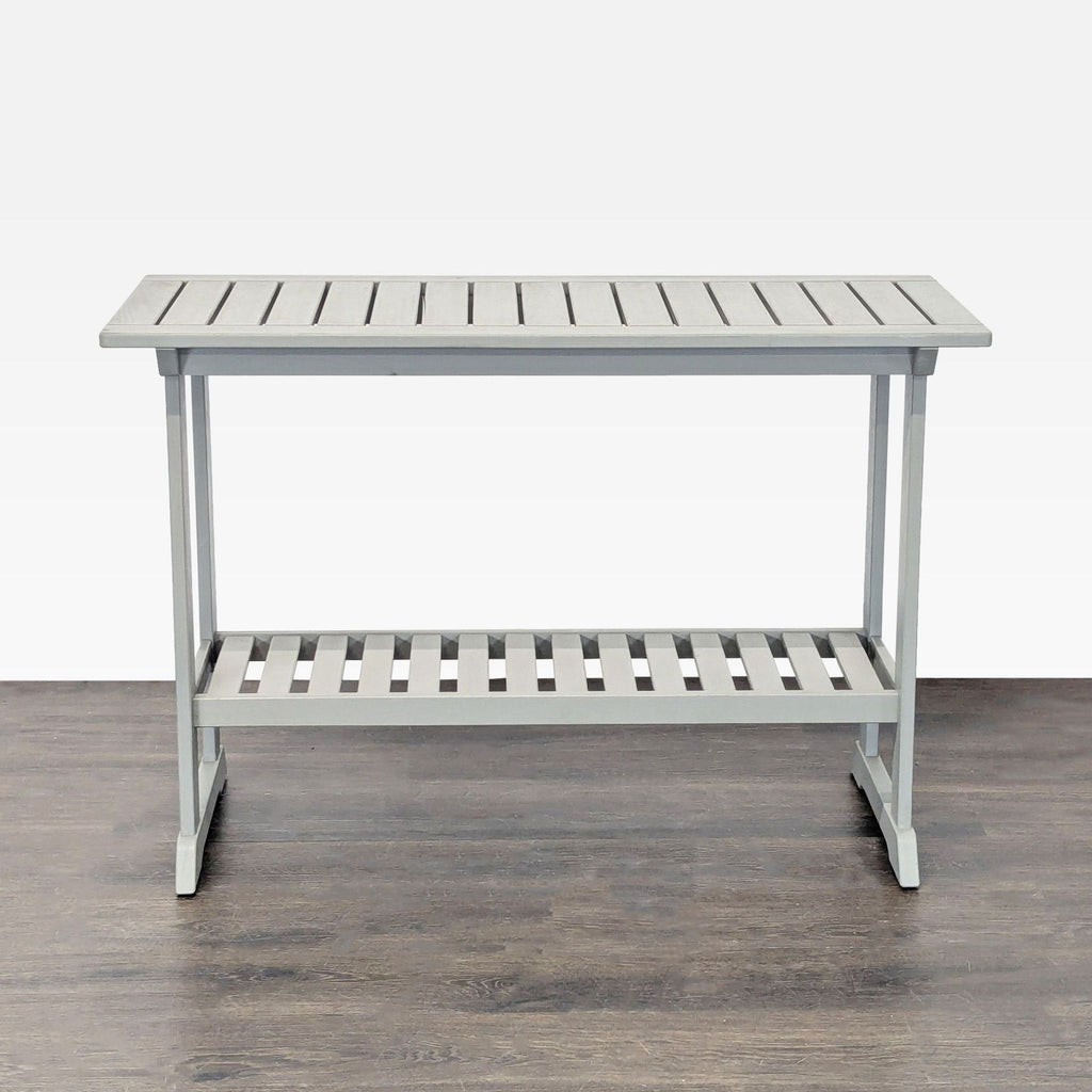 Sturdy, space-saving Ikea table with a sleek design, offering a slatted top and convenient bottom shelf.