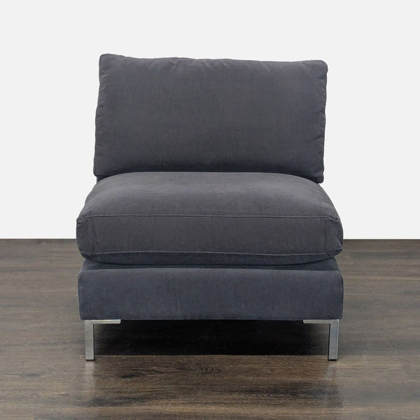 Modern CB2 lounge chair in dark gray fabric with plush cushions and metal legs, ideal for relaxing spaces.