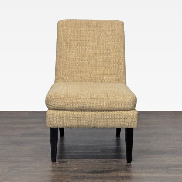 West Elm lounge chair with tan upholstery and dark wood legs, showcasing modern style and compact design.