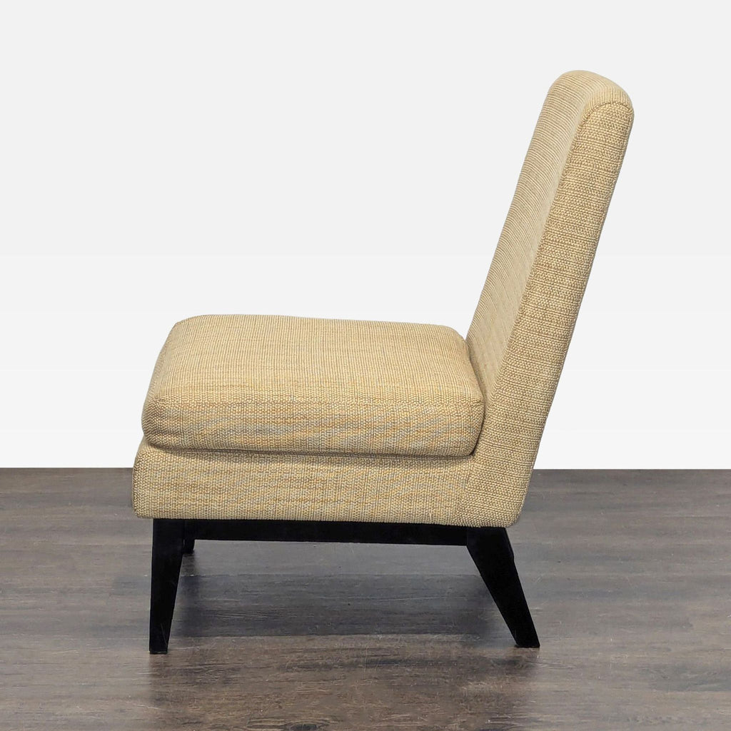Simple West Elm lounge chair with textured tan fabric and dark wood legs, perfect for seating in any lounge.