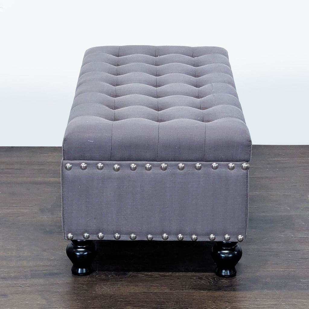 3. Stylish stool from Marshall’s, upholstered with button tufting and outlined in nailhead trim for added detail.