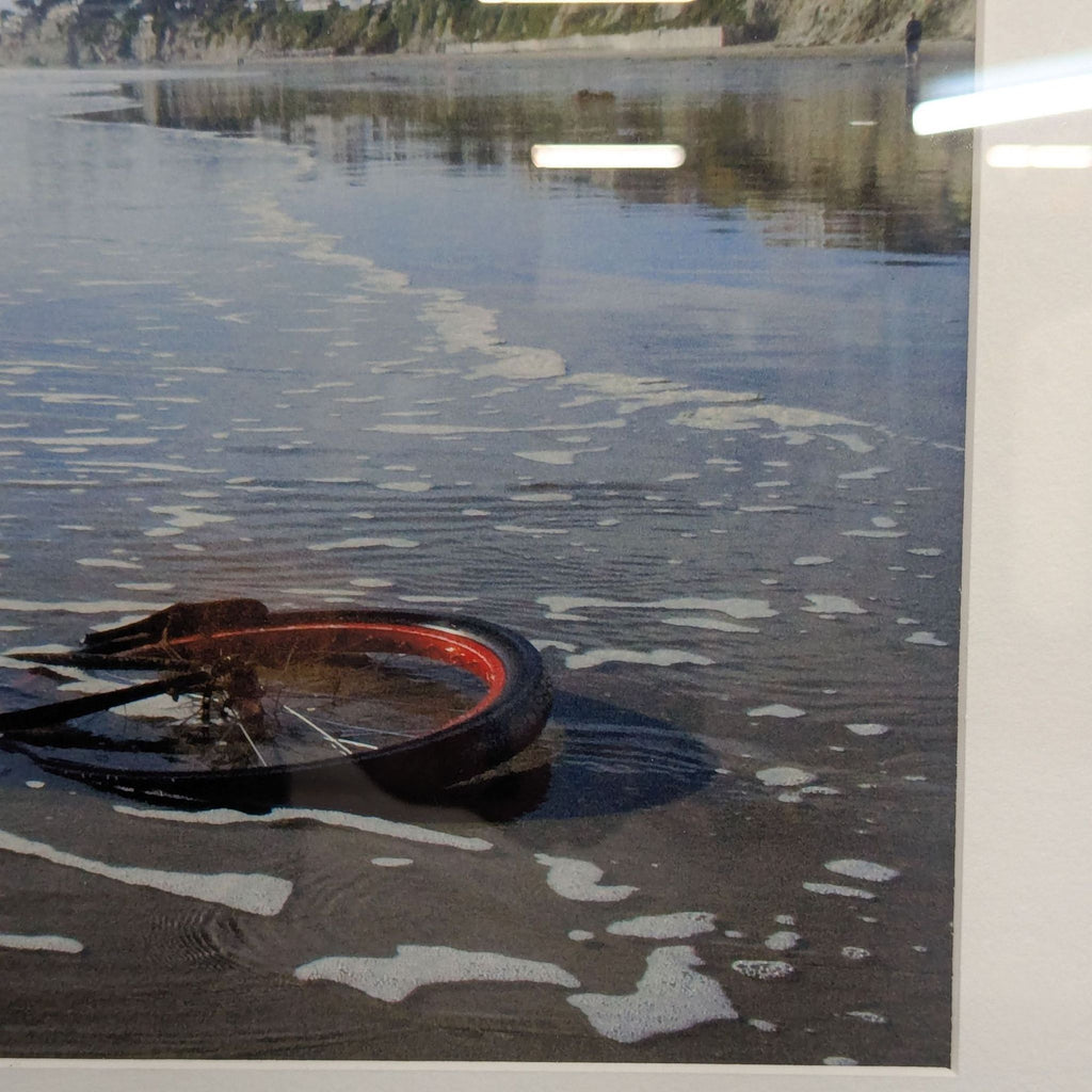 Framed Print – Abandoned Bicycle Wheel on Beach with Scenic View