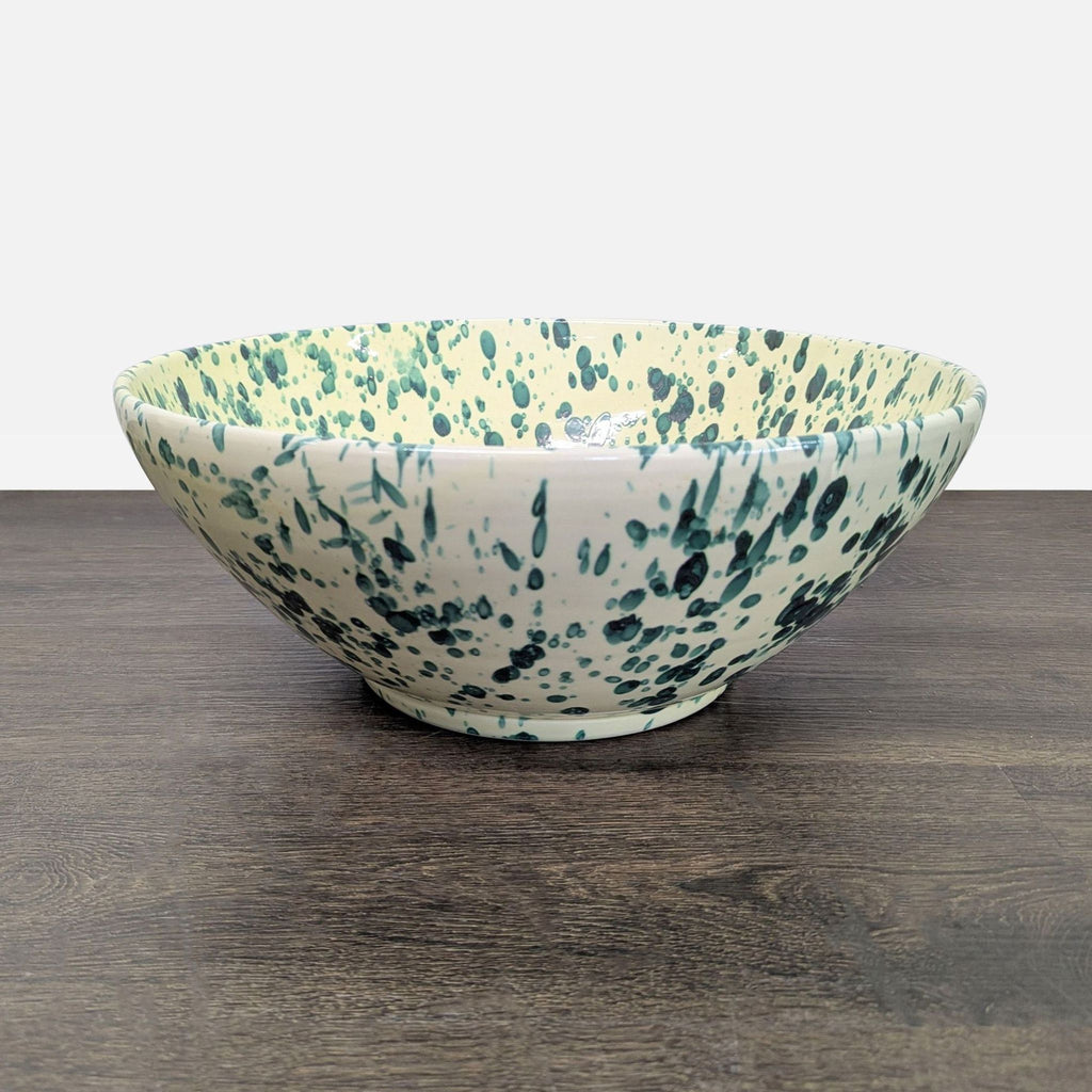 Handmade ceramic bowl with green splatter pattern on cream, by Ceramiche Nicola Fasano, perfect for serving salads.