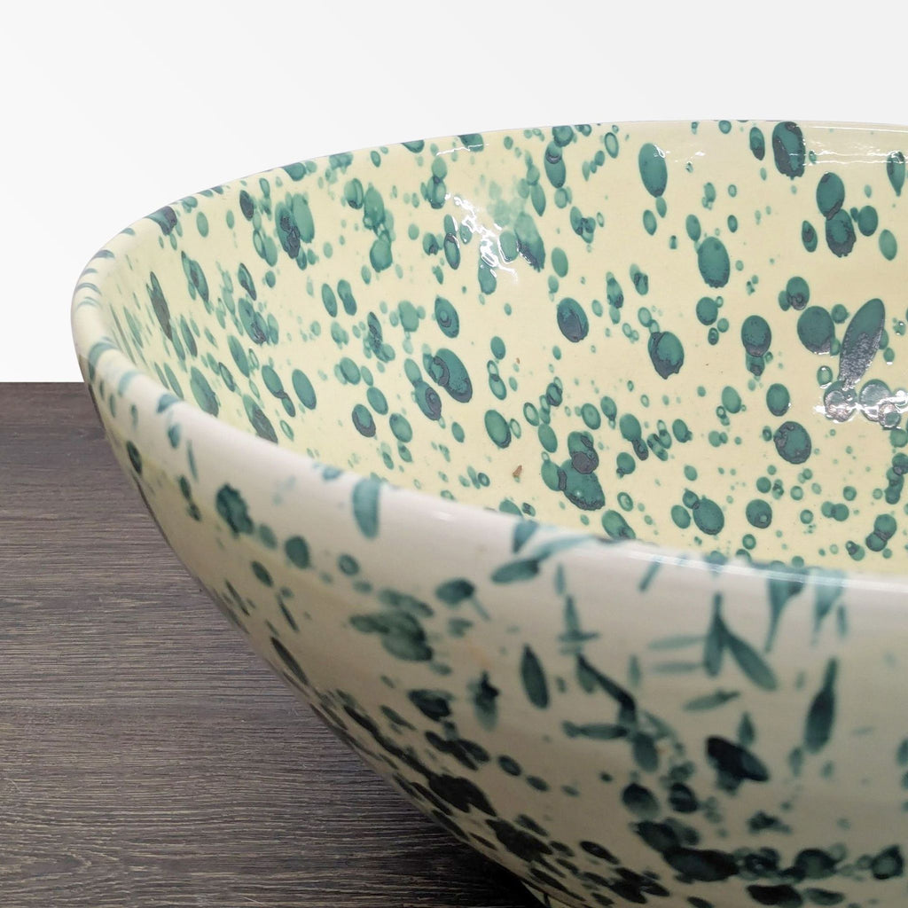 Stylish cream-colored ceramic bowl by Ceramiche Nicola Fasano, decorated with unique green splashes for dishware collections.