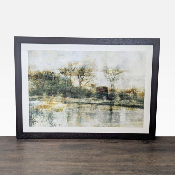 Framed landscape print with serene trees and water reflections, designed by Thea Schrack for Crate & Barrel.