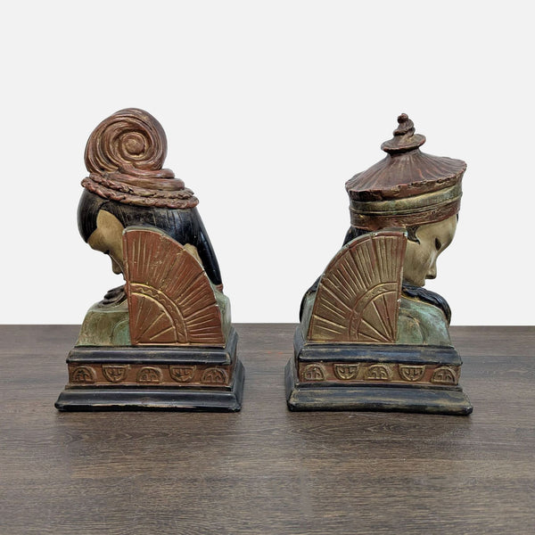 1. Pair of decorative bookends shaped like busts with intricate headpieces, fan motifs, and detailed bases.