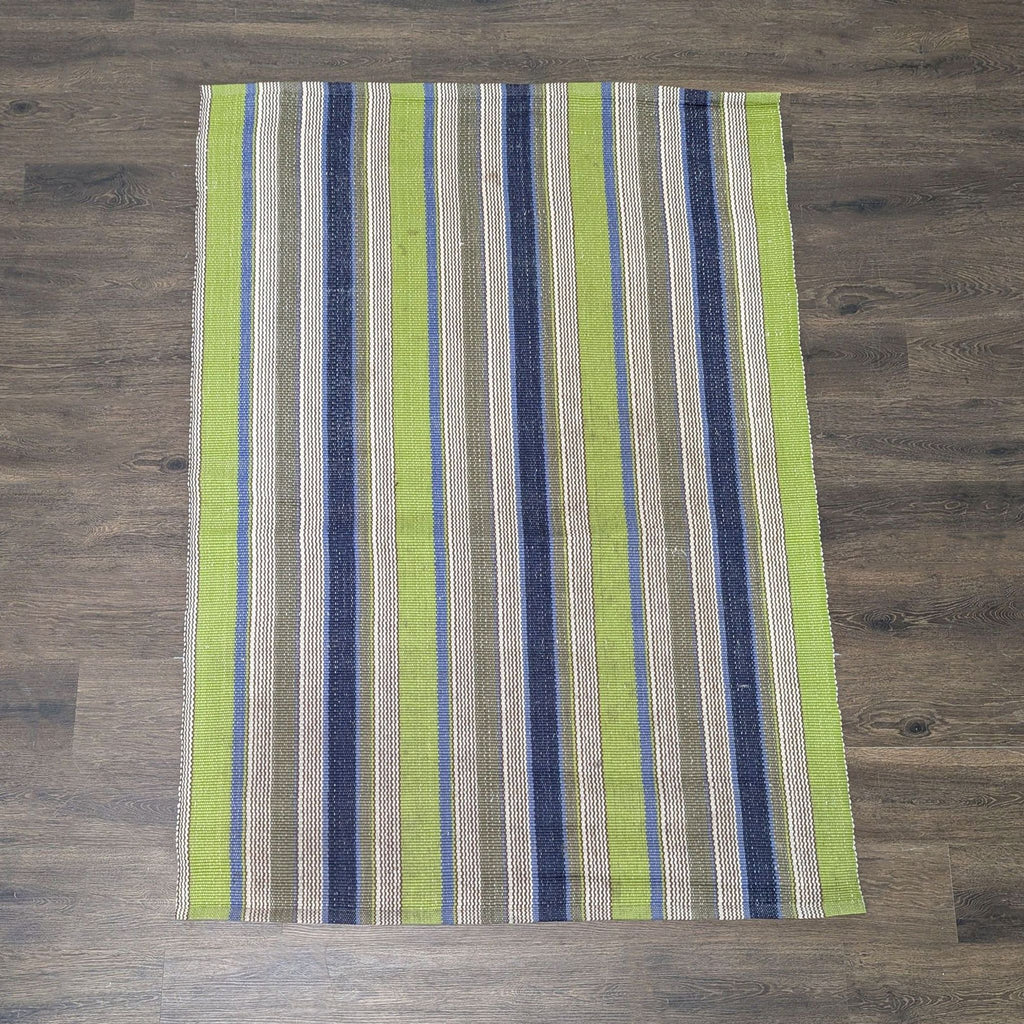 Dash & Albert striped woven rug featuring green, blue, brown, and cream colors, ideal for various rooms.  