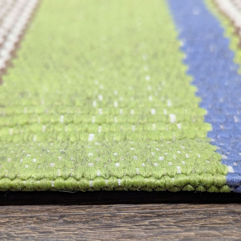 Colorful Dash & Albert area rug with green, blue, brown, and cream stripes, perfect for home décor.