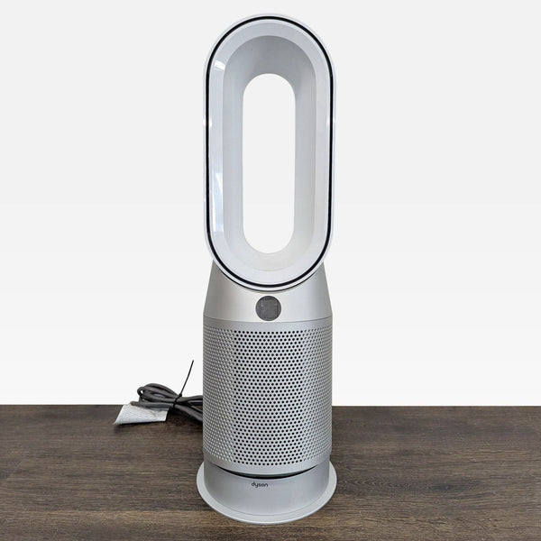 Dyson Pure Hot+Cool Link air purifier, heater, and fan with bladeless design, shown in a modern room.