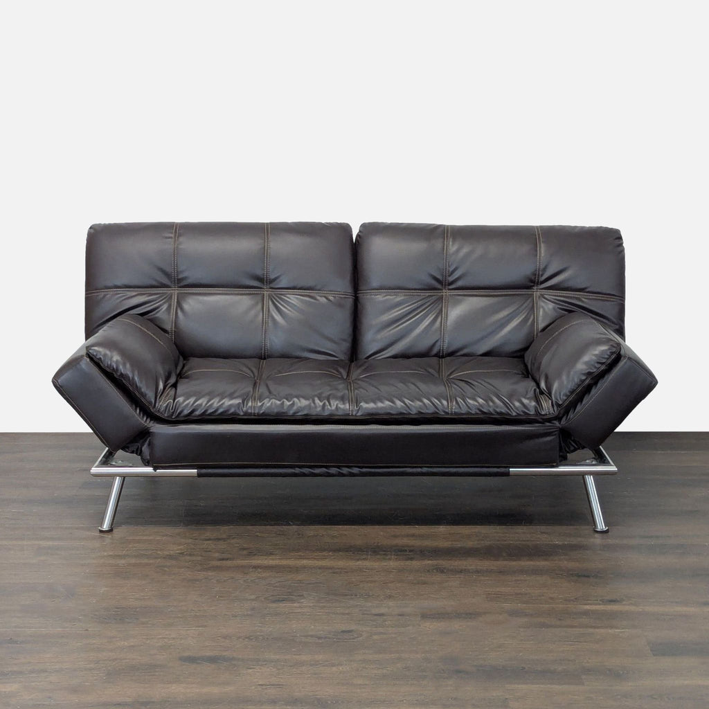 Sebu faux leather convertible sleeper sofa with tufted cushions and chrome frame in a minimalist modern style.