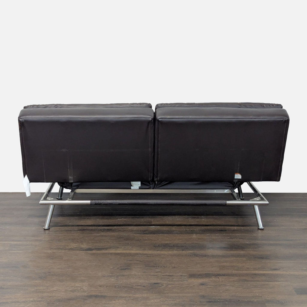 Sebu brand faux leather loveseat converts to bed, featuring polished chrome legs and sleek, minimalist design.