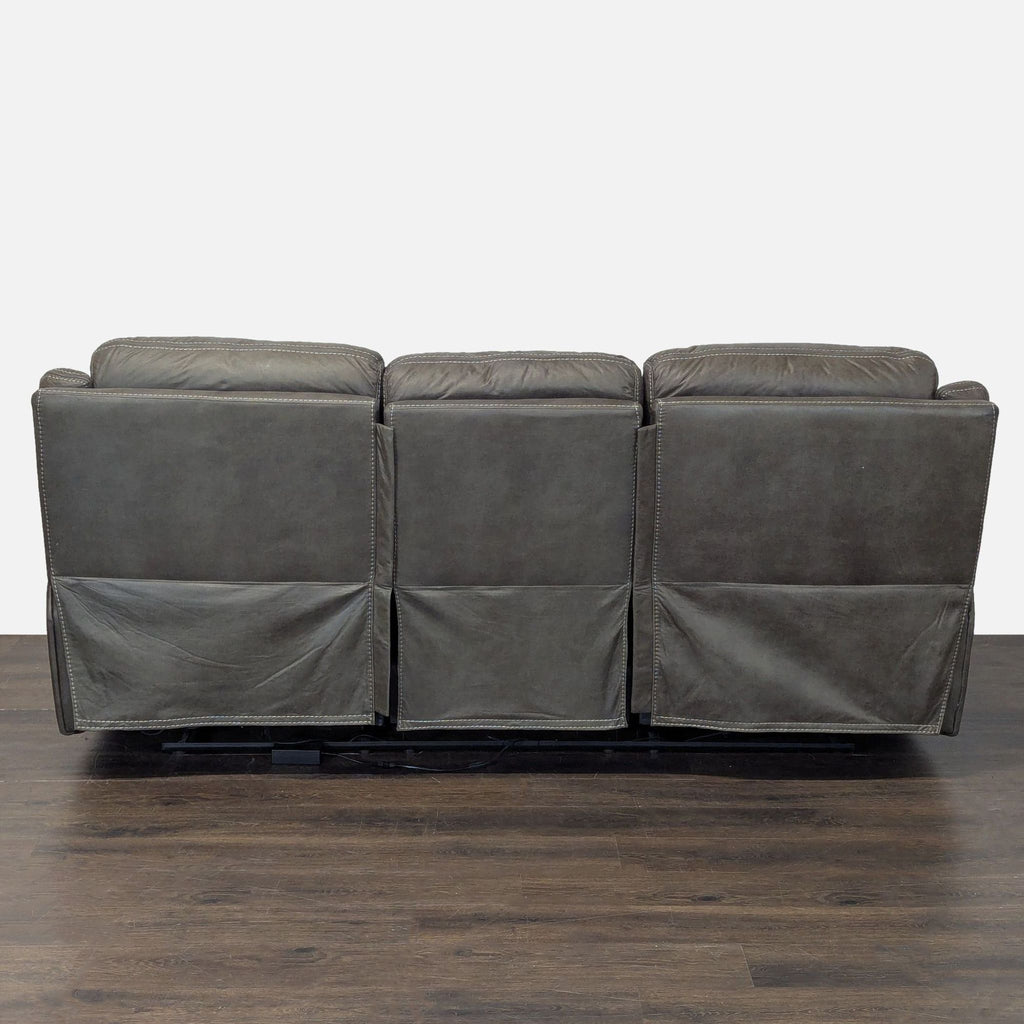 Comfortable leather 3-seater sofa with reclining sides, padded arms, and plush upholstery, perfect for living rooms.