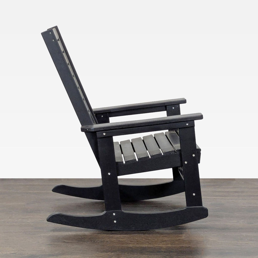 Sturdy black rocker chair with a slatted design, ideal for relaxing on your lounge, patio, or porch.