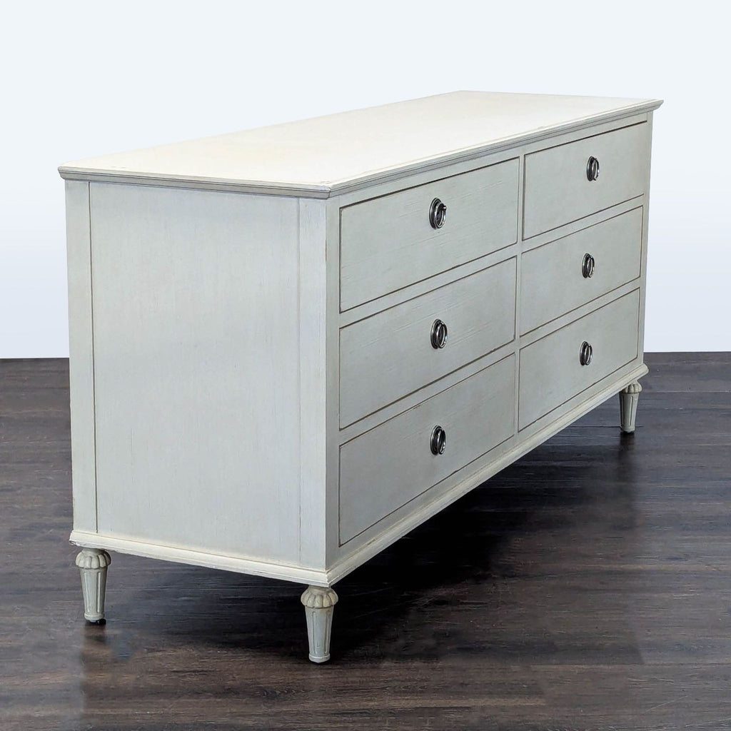 Classic six-drawer dresser in antique white with sturdy build and metal ring pulls, by Restoration Hardware.