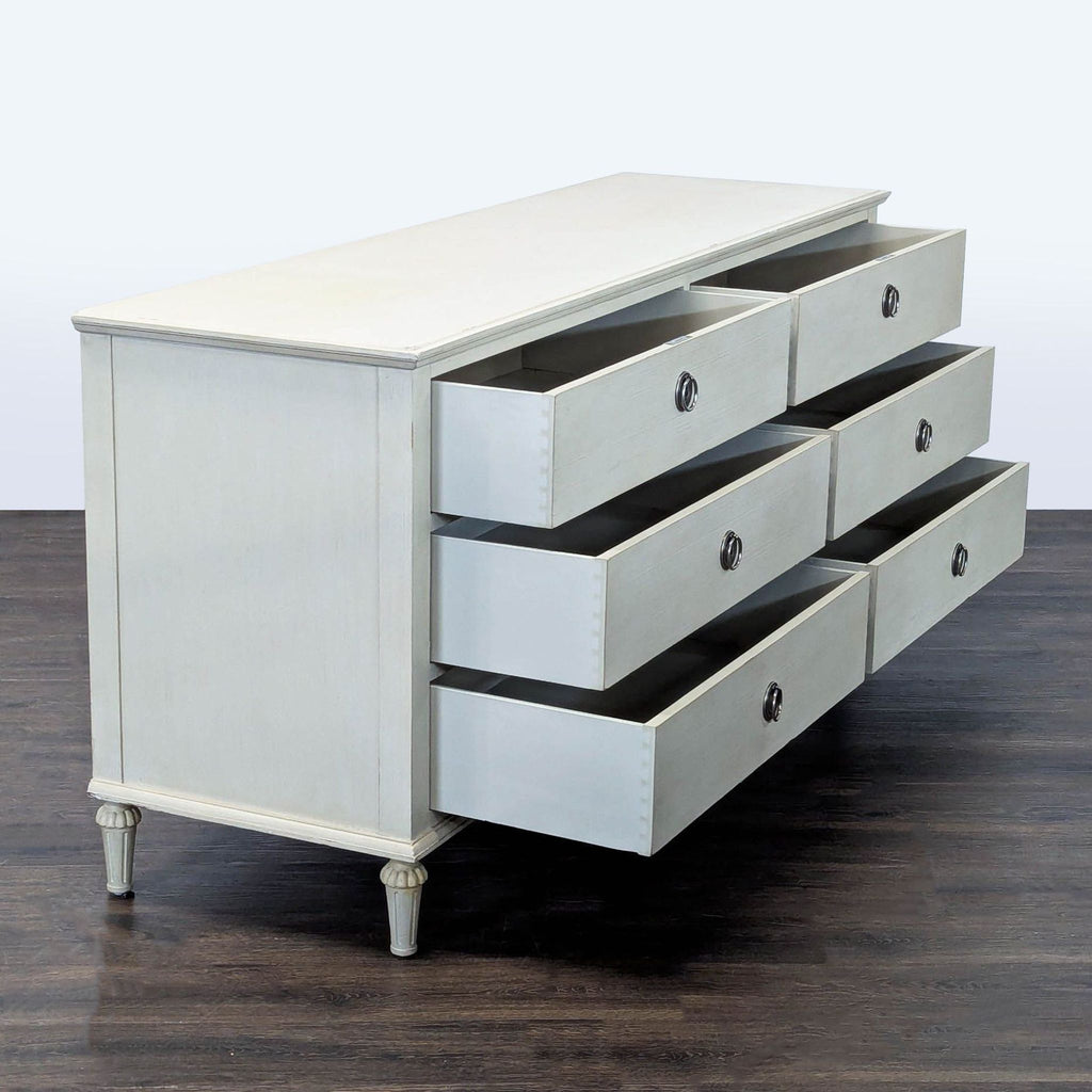 Restoration Hardware dresser in white featuring six spacious drawers and elegant ring handles for ample storage.  