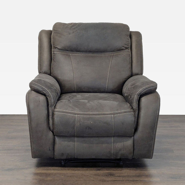 Plush dark gray power reclining lounge chair with padded armrests and high back, ideal for relaxation.