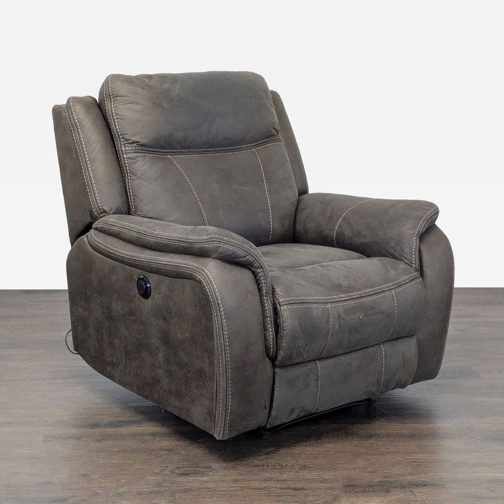 Comfortable power recliner with deep padding, user-friendly controls, and a sleek, dark gray design for lounges.