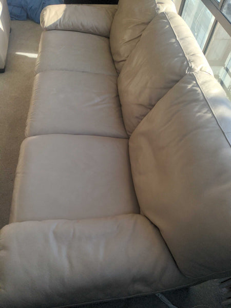 1. Italsofa 3-seat sofa in light beige leather, featuring three large seat cushions in a sunlit room.