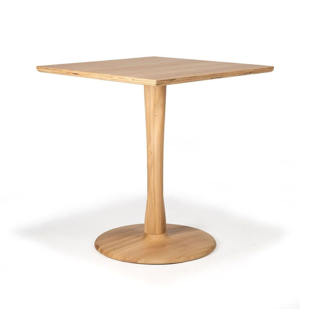 Ethnicraft Torsion dining table with a light wood top and a sculptural twisted wooden base.