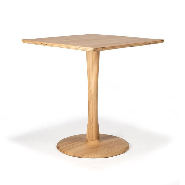 Ethnicraft Torsion dining table with a lightweight round wooden top and an elegantly twisted sculptural base.