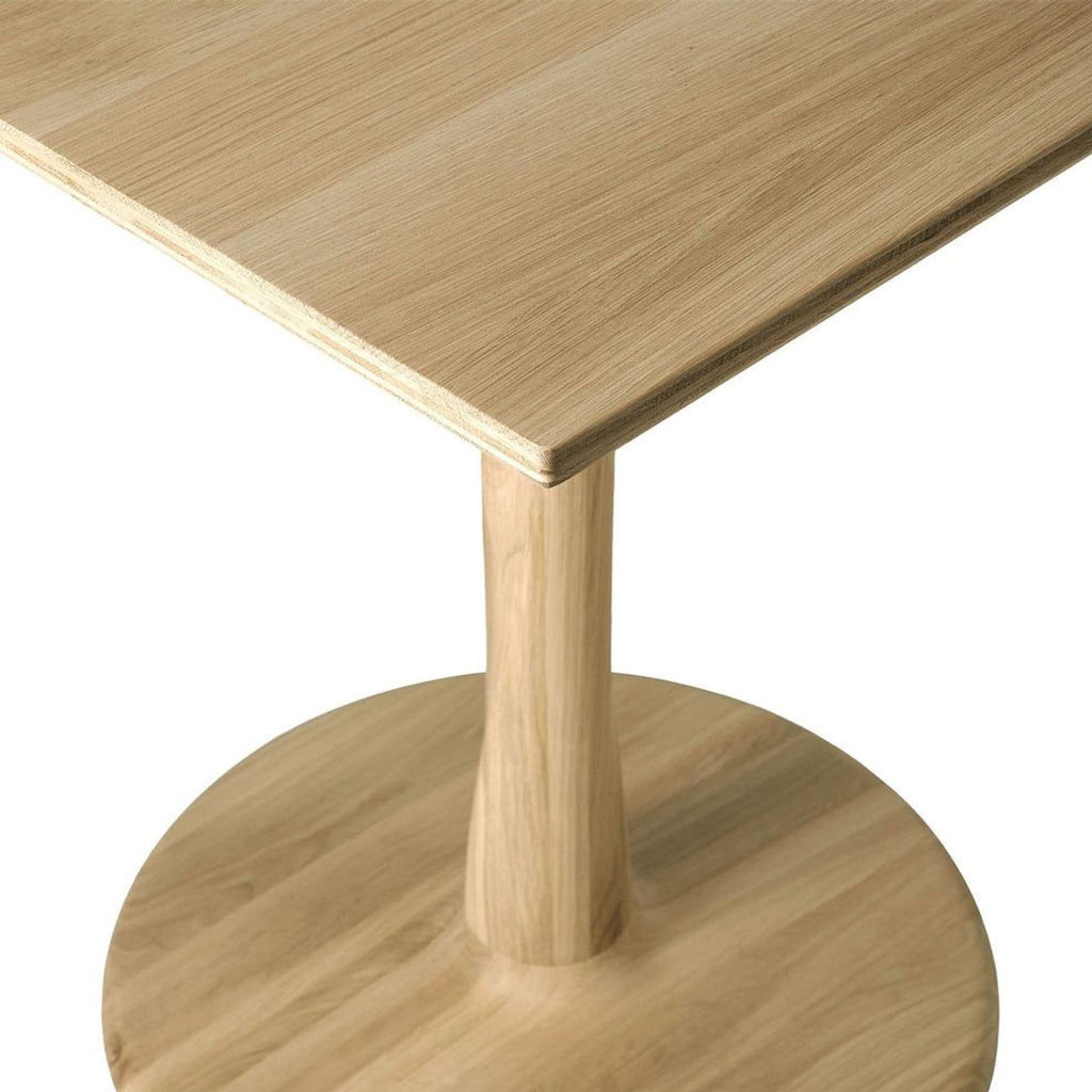 Modern dining table by Ethnicraft, showcasing advanced woodworking with a torsioned, decorative round base.