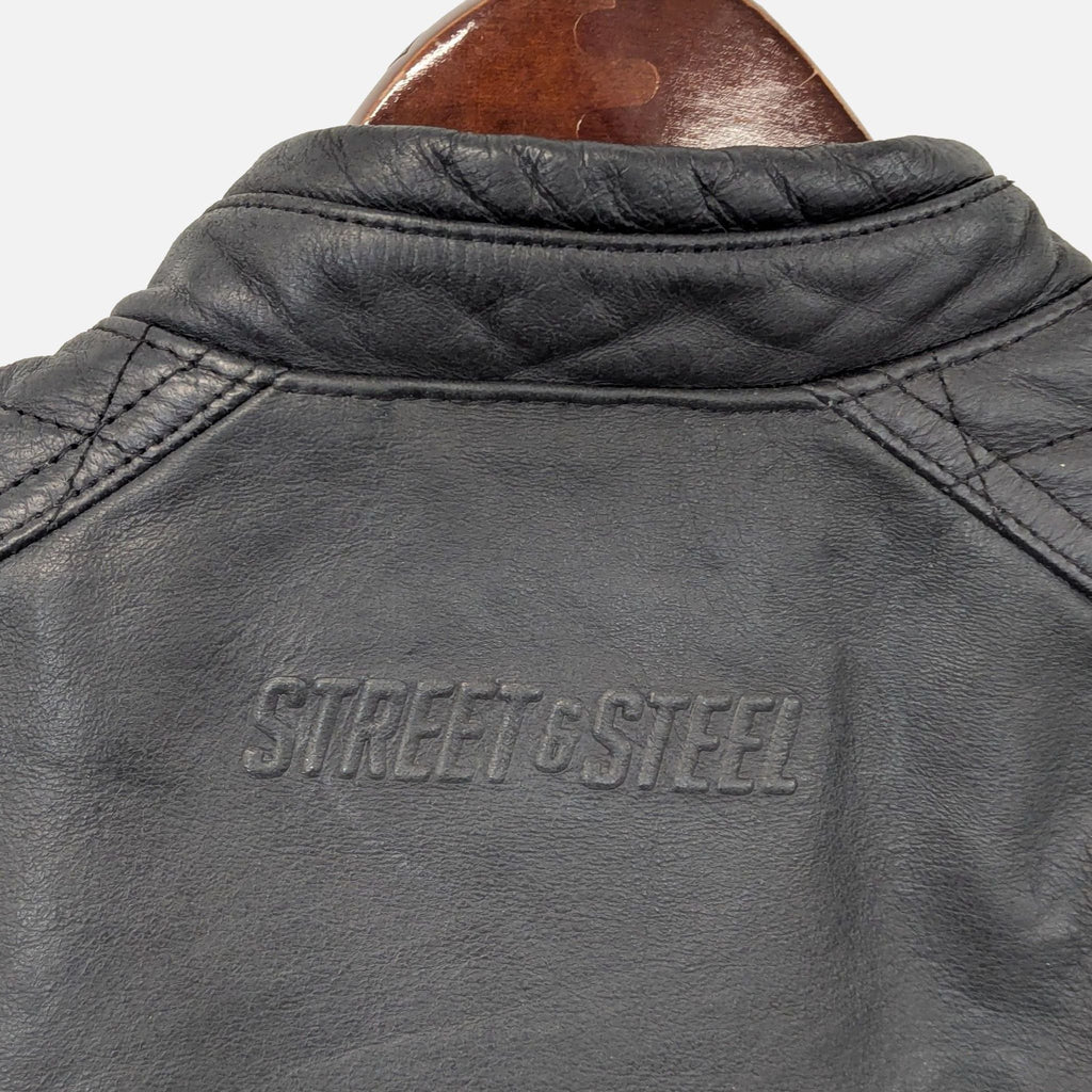 Used Street & Steel black leather riding jacket with zippered closure, quilted shoulders, and side pockets.