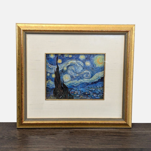 Framed art print of Van Gogh's "Starry Night" in a gold frame with a wide cream mat.