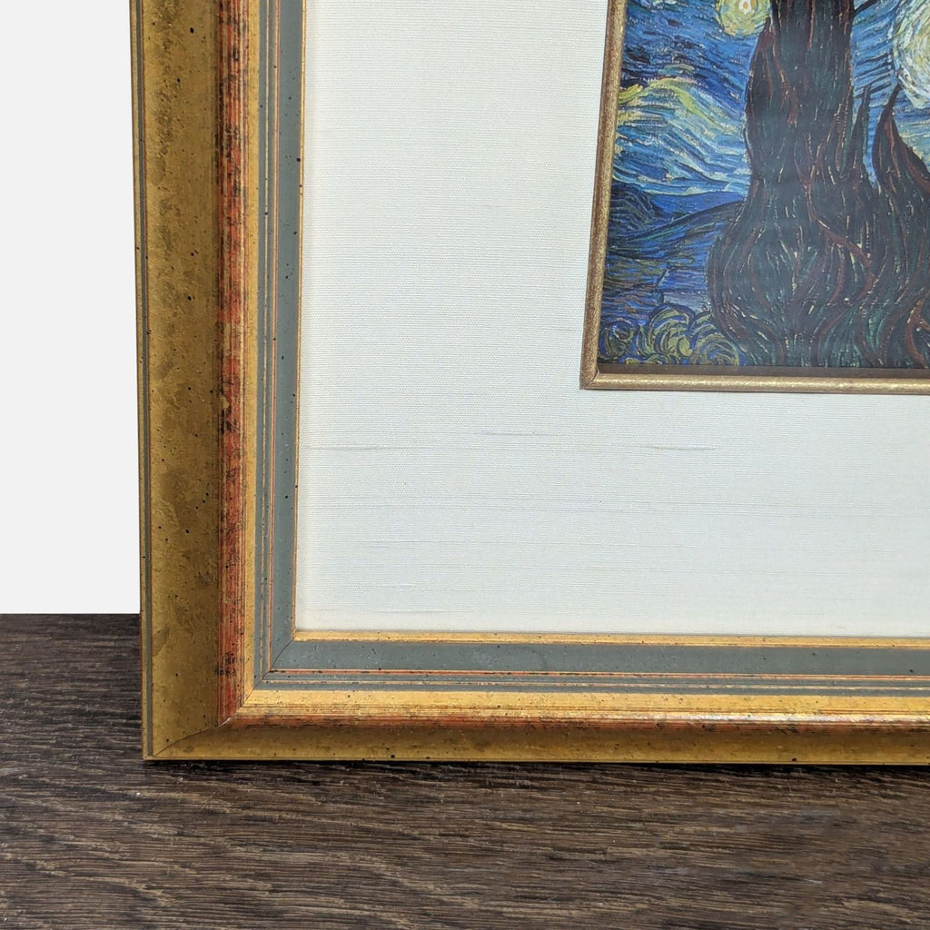 Gold-framed "Starry Night" print featuring Van Gogh’s iconic night sky and a cream mat border.