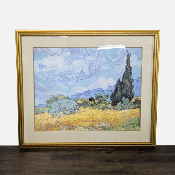 Framed Van Gogh "Wheat Field with Cypresses" print, gold border and mat, vibrant brushwork on display.