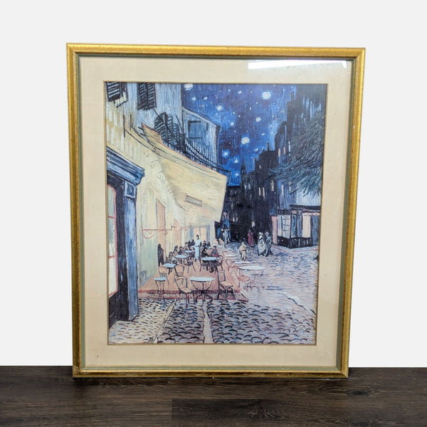 Framed print of Van Gogh’s “Café Terrace at Night” with vivid colors in a gold-tone frame, ready to hang.  