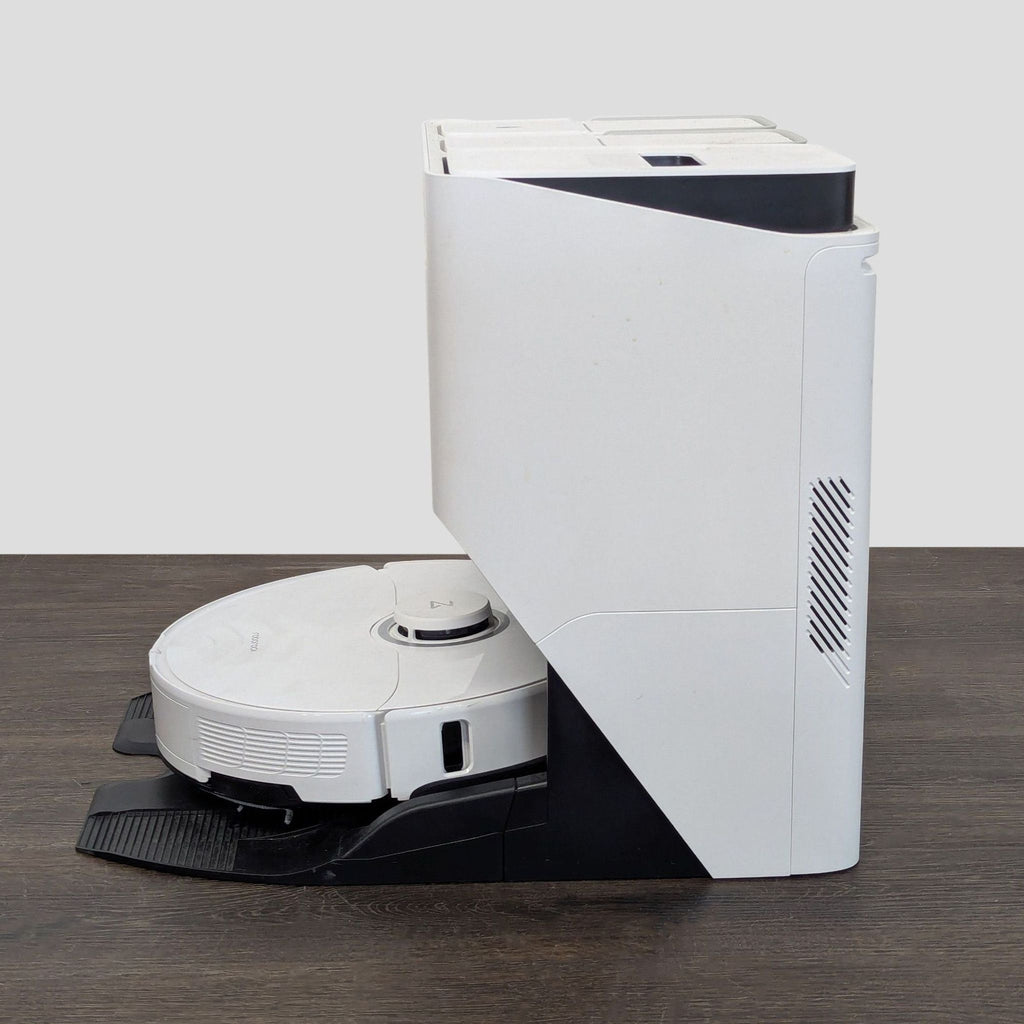 Roborock automated vacuum and mop system shown with an all-in-one charging station for hassle-free cleaning.