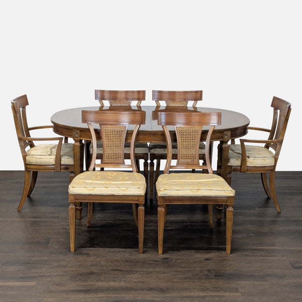 Thomasville oval dining table with three leaves and six cane-back chairs in warm walnut finish.