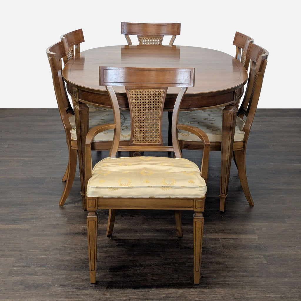 Classic Thomasville dining set: oval table, six cane-back upholstered chairs, brass-tone accents.
