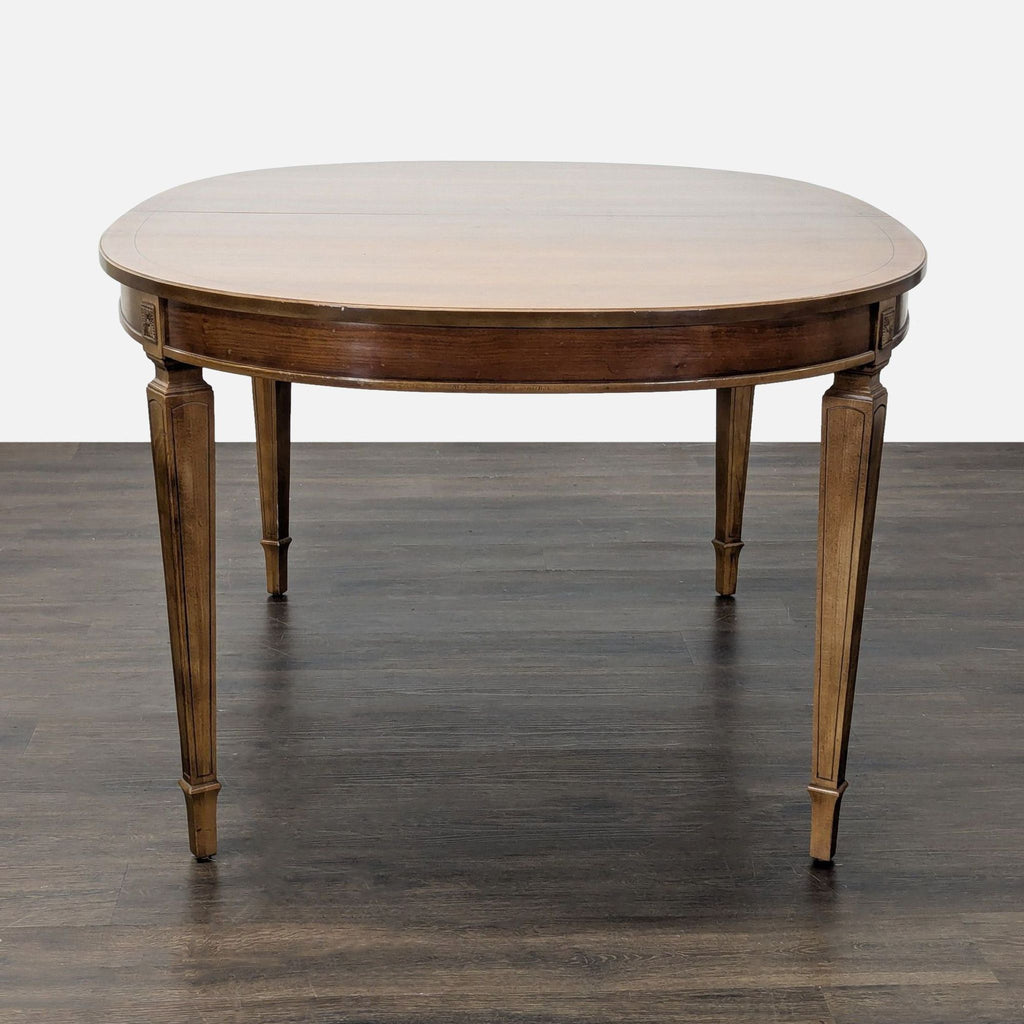 Traditional Thomasville set featuring a walnut oval extension table and six matching cane-back chairs.