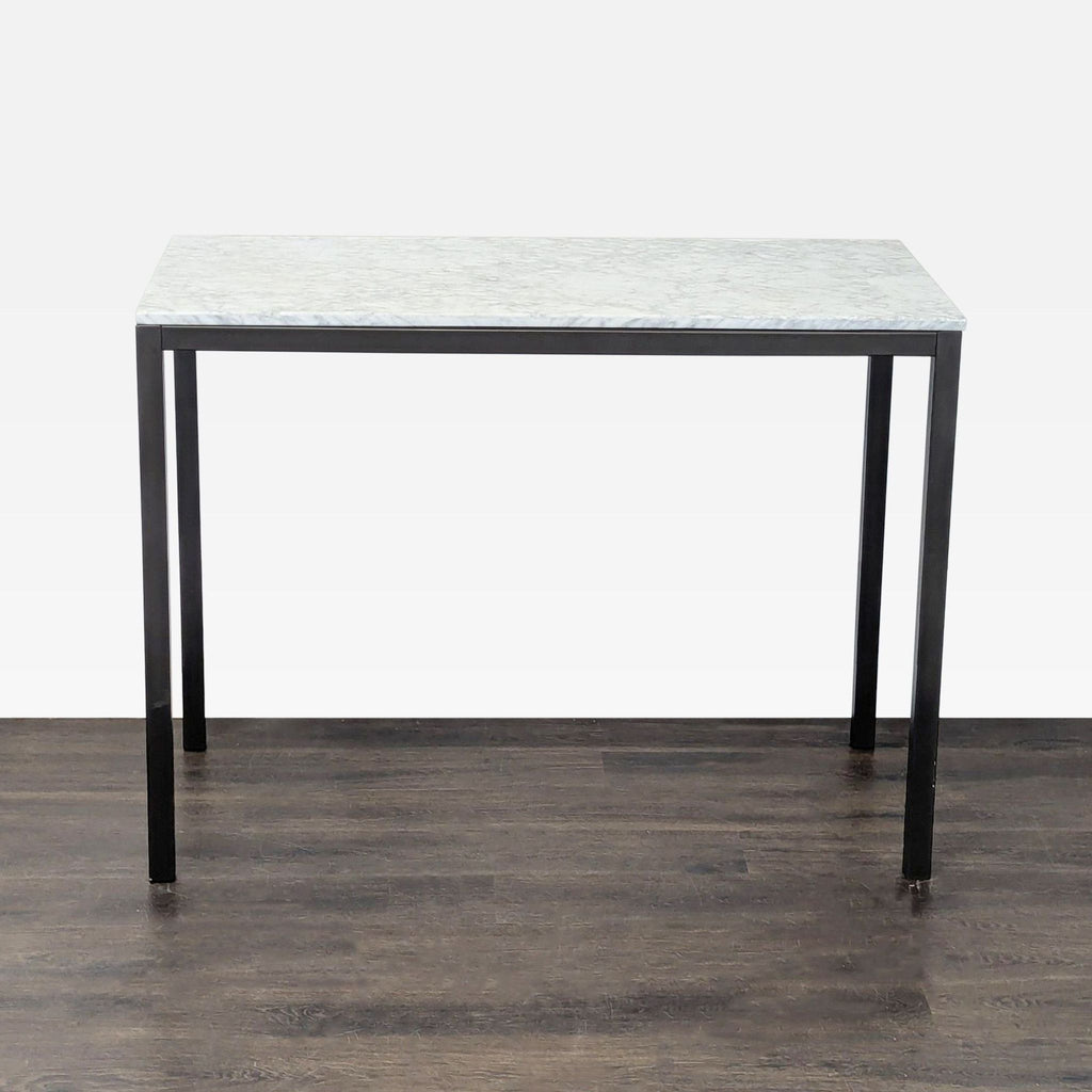 Dining table featuring a black steel frame and Carrara marble top, displaying unique marble color variations.