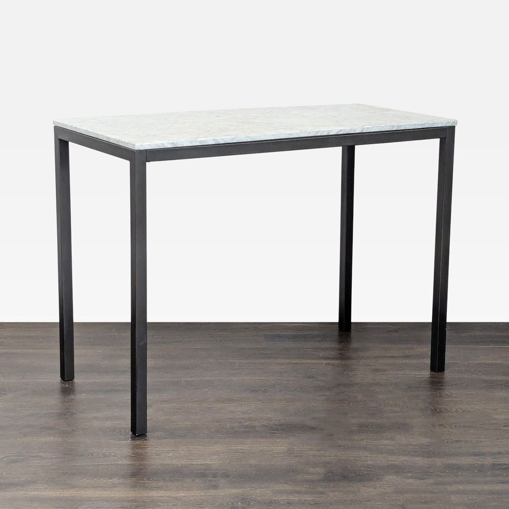 West Elm dining table with a Carrara marble top and black finished steel frame, highlighting natural veining.