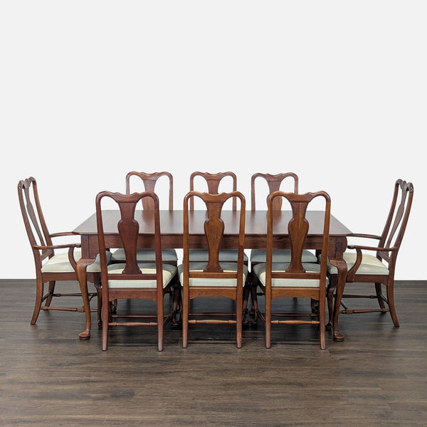 1. Elegant cherry dining set with cabriole legs, two extension leaves, and eight coordinated upholstered chairs.  