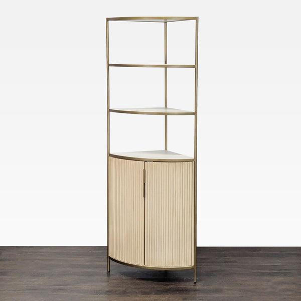 Crate & Barrel corner bookshelf with metal frame, open shelves, and a two-door cabinet for hidden storage.