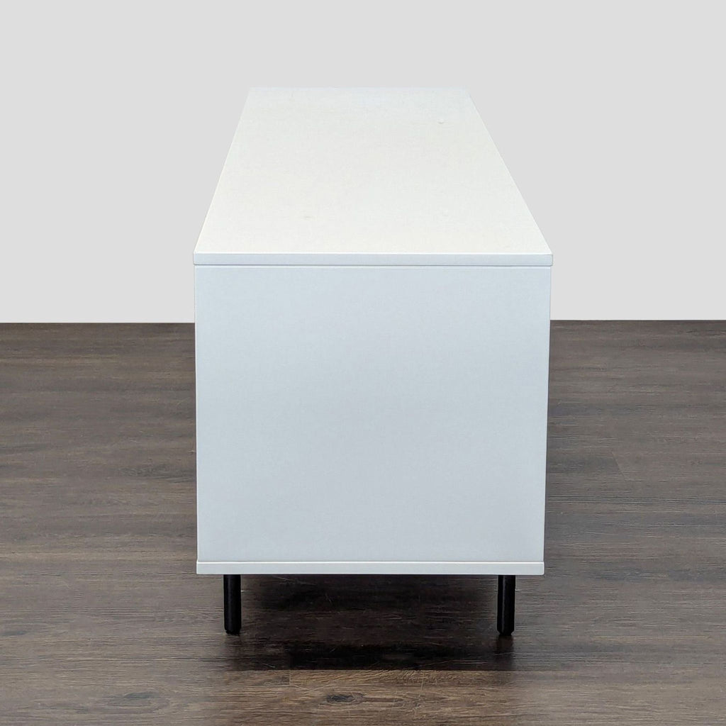 West Elm entertainment center featuring a metal base, lacquer details, and reclaimed wood in Mid-Century design.