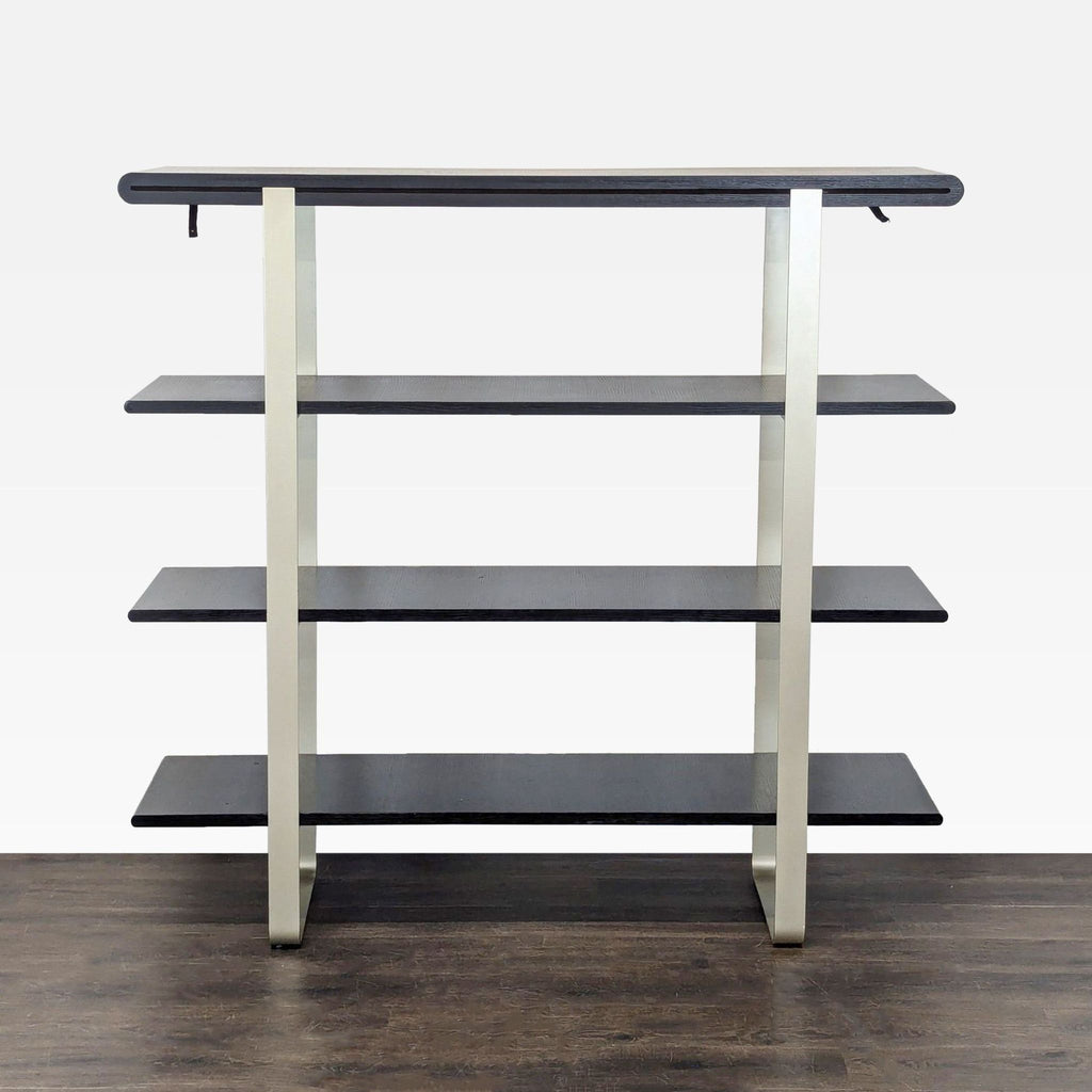 A modern bookshelf with four black wooden shelves and a sleek metal frame, ideal for displaying books or decor.